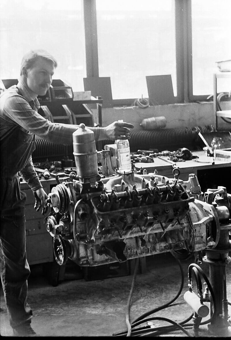 a historic picture of a man working on an engine in Kuusalu Factory